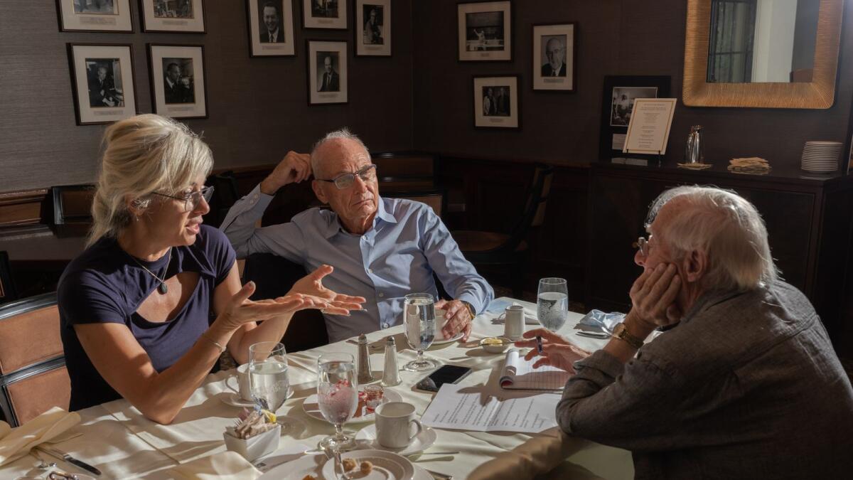 From left, Maria Spiropulu of the California Institute of Technology, and Michael Turner of the University of Chicago, join the reporter Dennis Overbye for breakfast at The Athenaeum on the California Institute of Technology campus in Pasadena, California. (Stephen Ross Goldstein/The New York Times)