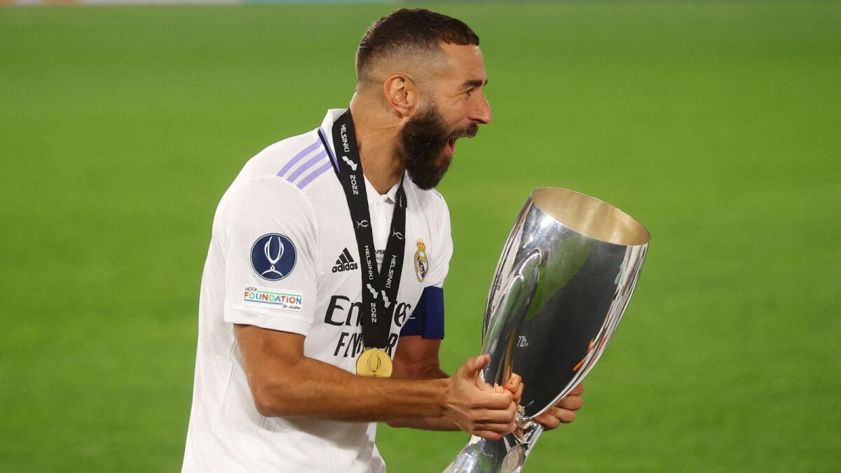 Real Madrid's Karim Benzema celebrates with the Uefa Super Cup trophy. — Reuters
