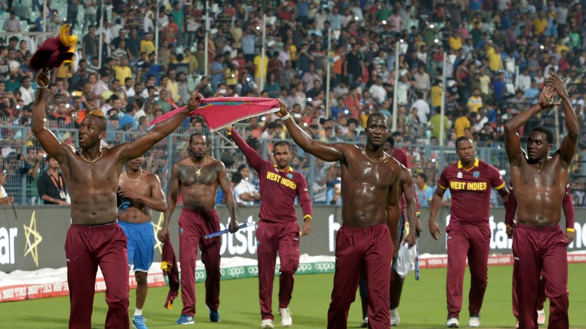 West Indies's players led by captain Darren Sammy(C)celebrate after victory in the World T20 cricket tournament final match between England and West Indies at The Eden Gardens Cricket Stadium in Kolkata on April 3, 2016.