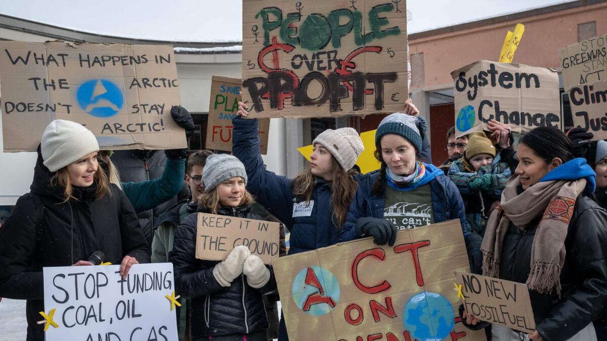 Germany's Luisa Neubauer (L), Sweden's Greta Thunberg (2nd L) and other young climate activists of the 'Fridays for Future' movement stage an unauthorised demonstration on the closing day of the World Economic Forum (WEF) annual meeting in Davos on  Friday. - AFP