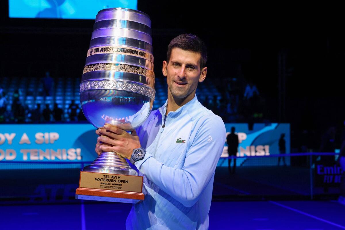Novak Djokovic poses with the trophy after winning the final in the Tel Aviv Open on Sunday. (AFP)