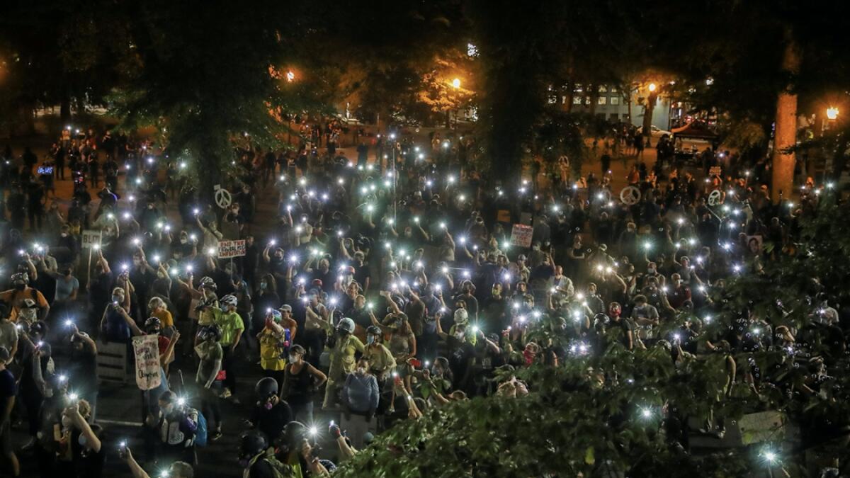 People shine cellphone flashlights during a demonstration against racial inequality and police violence in Portland, Oregon, US. Photo: Reuters
