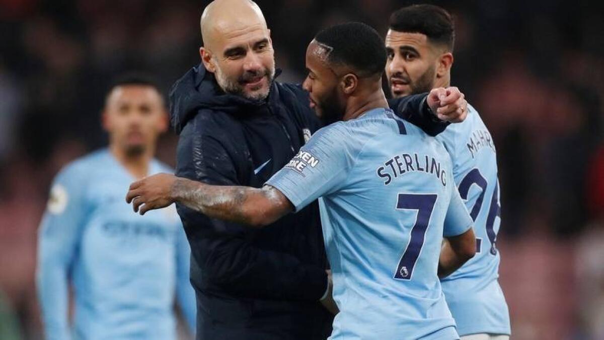Manchester City manager Pep Guardiola with Raheem Sterling. - Reuters file