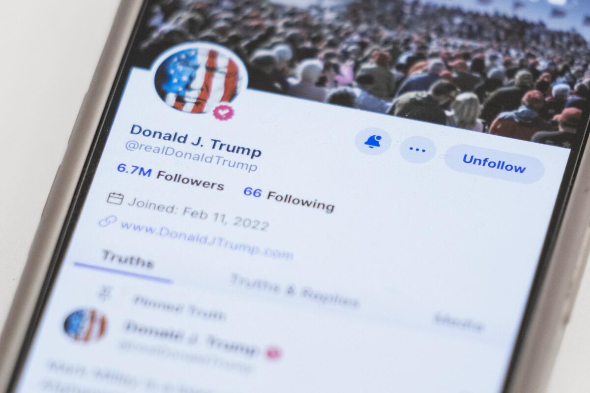 The Truth Social account for former President Donald Trump is seen on a mobile device. Many of Trump Media’s investors are small-time investors either trying to support Trump or aiming to cash in on the mania. — AP