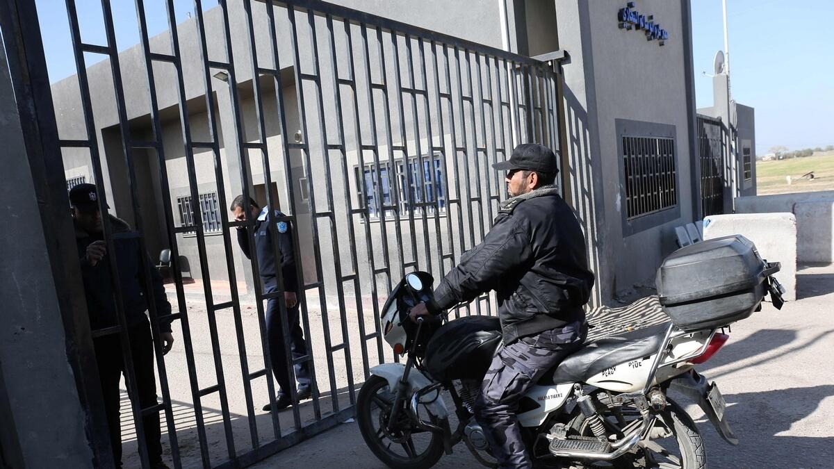 A member of the Palestinian security forces loyal to Hamas sits on a motorcycle outside the Kerem Shalom crossing.- AFP