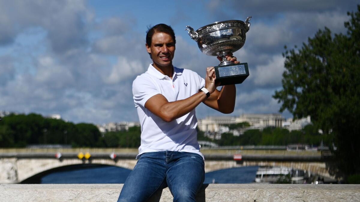 Rafael Nadal of Spain poses with the trophy on Alexandre III bridge in Paris, a day after his 14th victory at the French Open. (AFP)