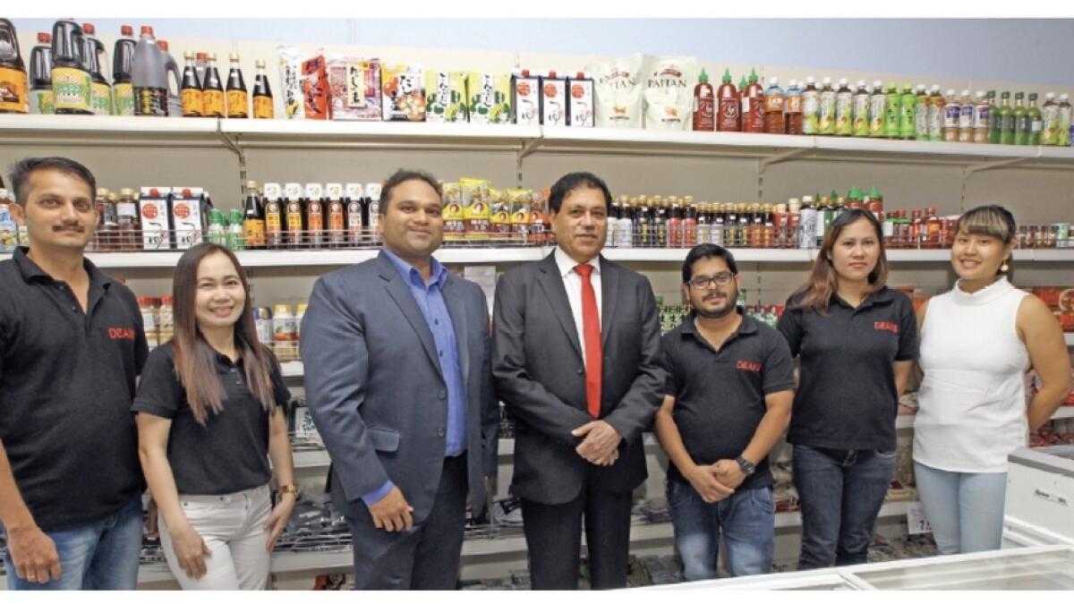 Sreenivas Panikkan and Dhil Sreenivas with the staff of Deans Fujiya supermarket
