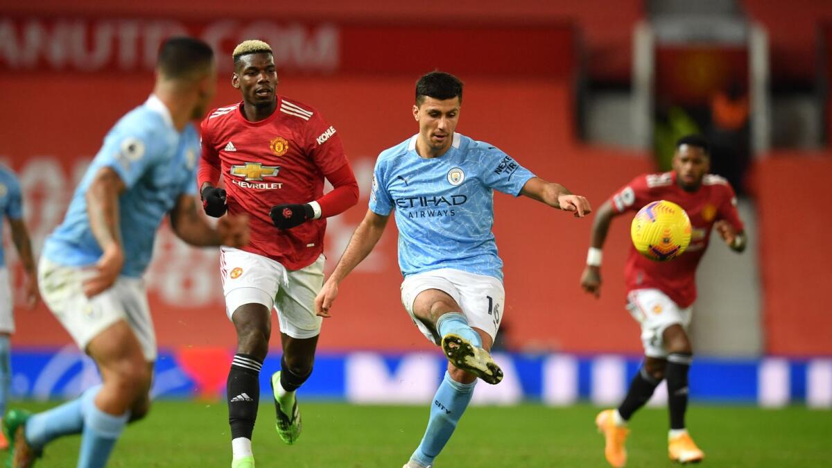 Manchester City's Rodrigo in action with Manchester United's Paul Pogba. — AFP