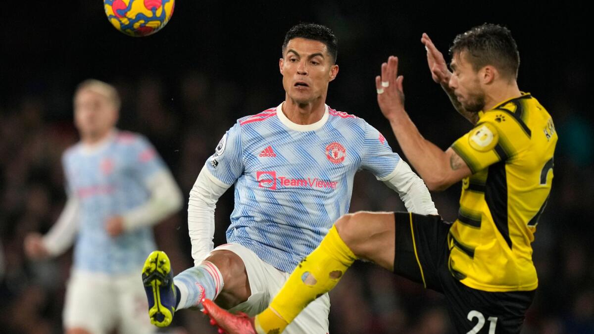 Manchester United's Cristiano Ronaldo (left) vies for the ball with Watford's Kiko Femenia. (AP)