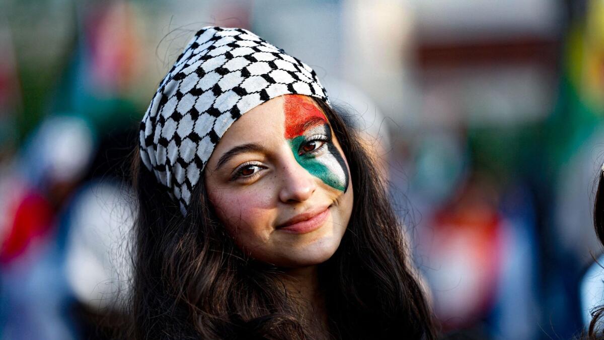 The Palestinian flag is painted on the eye of a young girl during a march to show solidarity with the Palestinians in the southern Lebanese city of Sidon. — AFP
