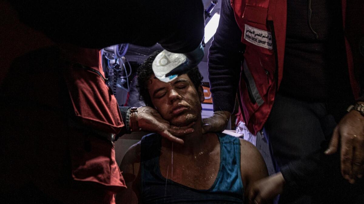 A protestor suffers from asphyxiation due to tear gas in Iraq. Emma Francis