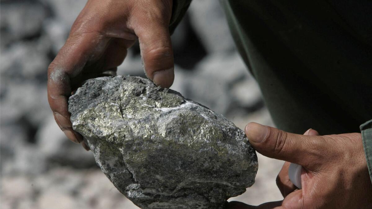 A worker holds a rock at the Al Amar gold mine, 200km  southwest of Riyadh, May 28, 2008. The Al Amar mine, an underground deposit in Saudi Arabia, mainly contains gold and zinc.   — Reuters