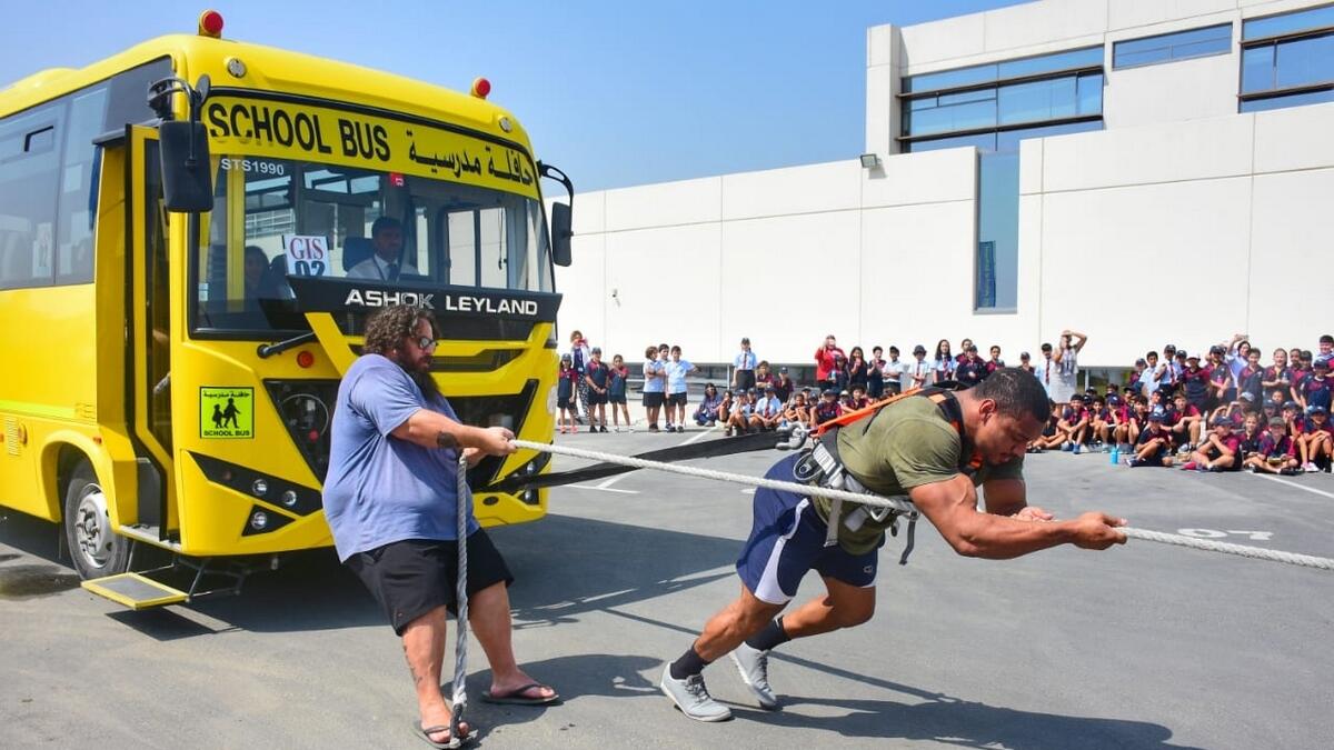 Strongman, Dubai school bus, man pulls bus in Dubai