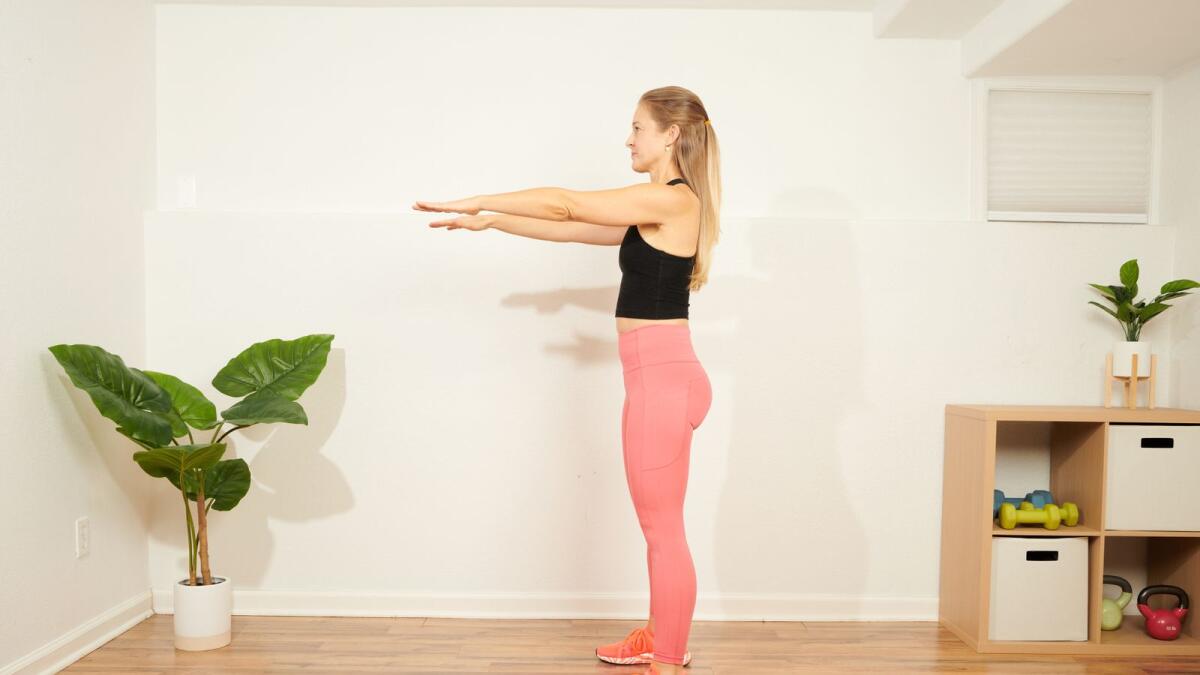 Jessica Valant, a physical therapist and Pilates instructor, demonstrates the beginning of a squat, at her home studio in Denver, Jan. 9, 2023.  (Theo Stroomer/The New York Times)