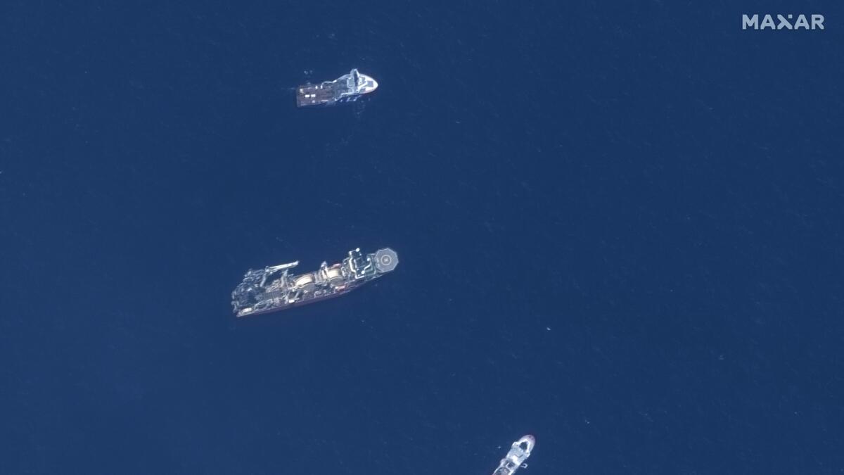 In this satellite image provided by Maxar Technologies, from top to bottom, the vessels Horizon Arctic, Deep Energy and Skandi Vinland search for the missing submersible Titan, Thursday, June 22, 2023, in the Atlantic Ocean.
