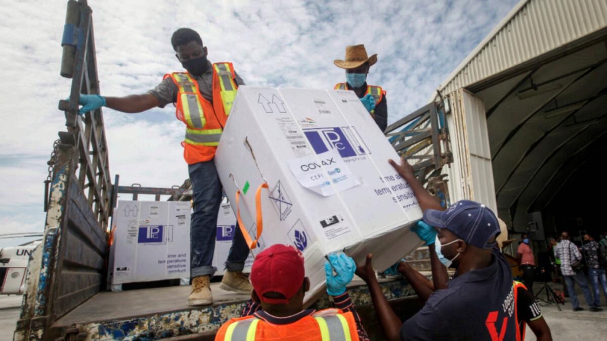 Workers offload AstraZeneca/Oxford vaccines under the COVAX scheme at the Aden Abdulle Osman Airport in Mogadishu, Somalia. — AP