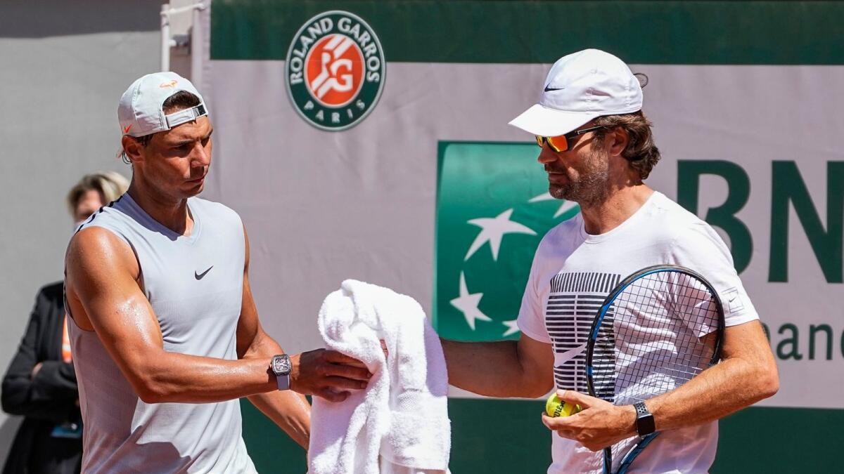 Spain's Rafael Nadal (left) with his coach Carlos Moya during a training session at Roland Garros stadium ahead of the French Open tennis tournament in Paris. — AP