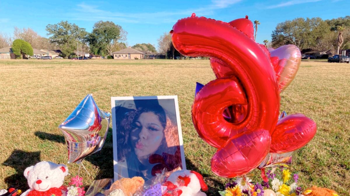 A makeshift memorial sits near the side of a street in Houston, next to a large grassy area where Diamond Alvarez was fatally shot. — AP