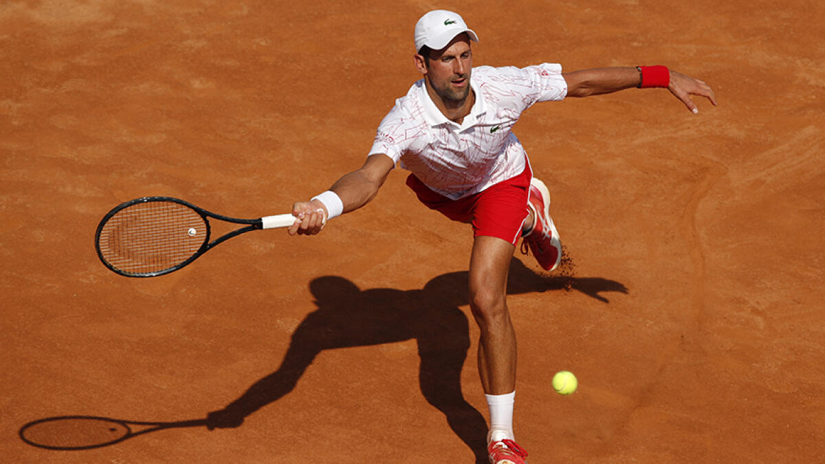 Novak Djokovic plays a forehand to Italy's Salvatore Caruso on day three of the Italian Open at Foro Italico in Rome, Italy on Wednesday. -- AFP