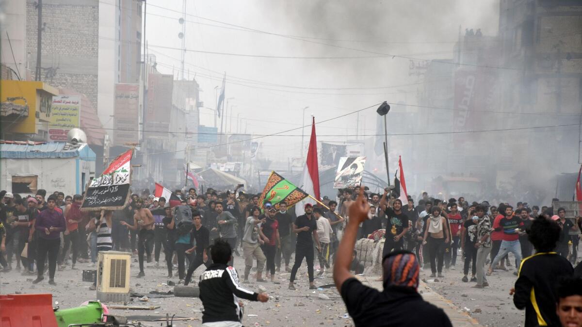 Anti-government protesters clash with supporters of Iraqi Shi'ite cleric Moqtada al-Sadr in Nassiriya, Iraq November 27, 2020.