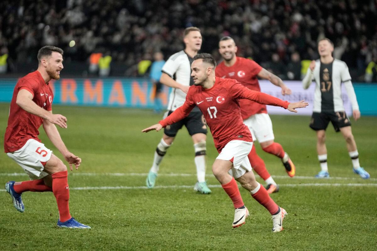 Turkey's Yusuf Sari celebrates after he scored his side's third goal. — AP