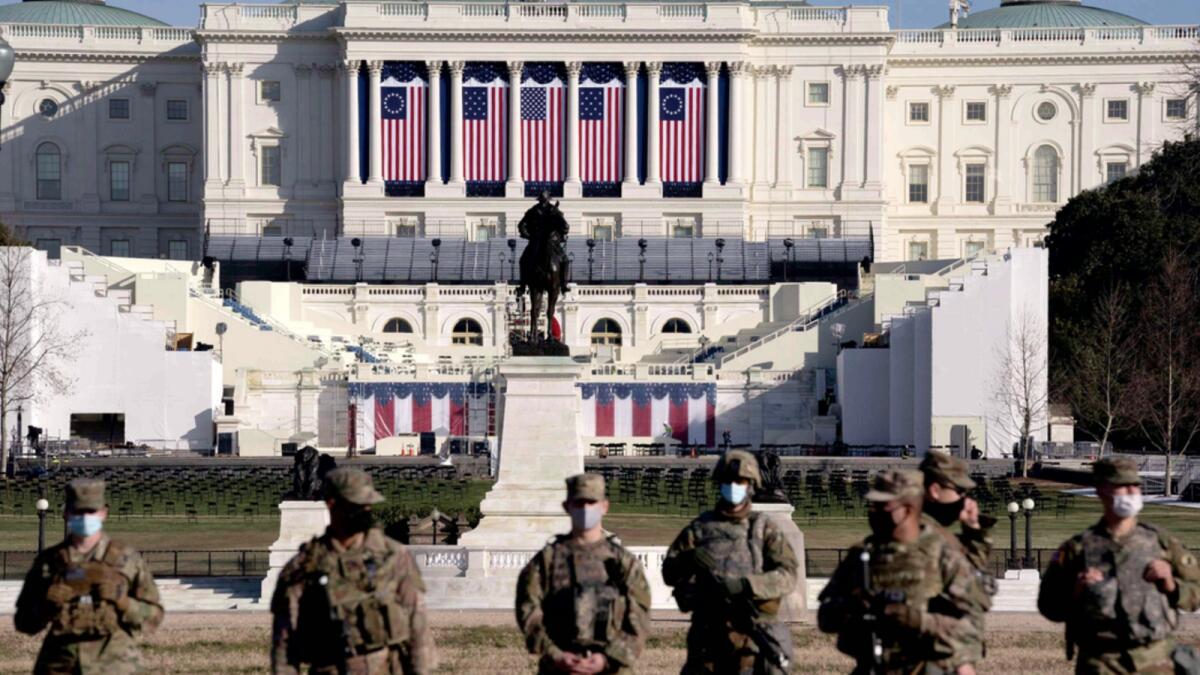Members of the National Guard stand outside the US Capitol on Thursday. Security has been increased throughout Washington following the breach of the US Capitol last Wednesday, and leading up to the Presidential Inauguration. — AFP