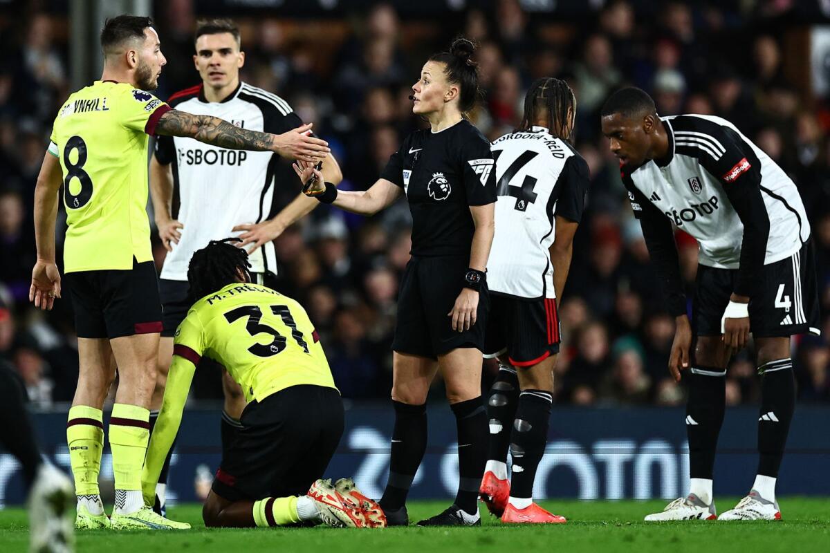 English referee Rebecca Welch speaks with Burnley's English midfielder Josh Brownhill (left) during the English Premier League football match between Fulham and Burnley. — AFP