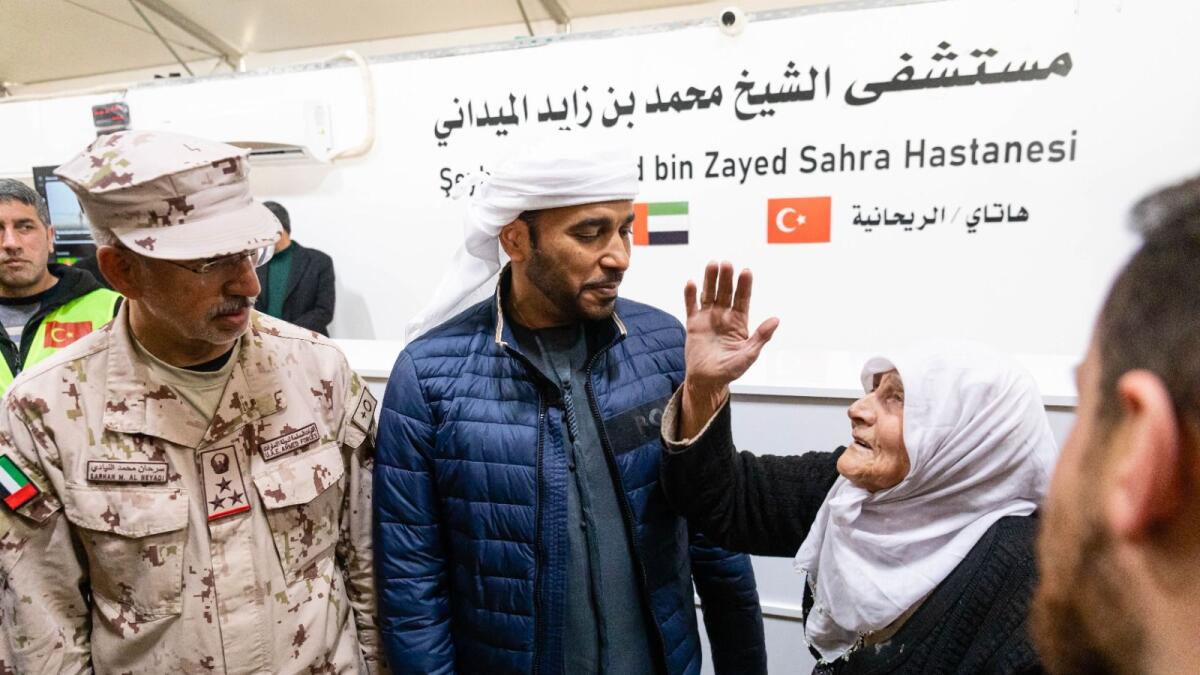 Saeed Thani Hareb Al Dhaheri, Ambassador of the United Arab Emirates to the Republic of Turkey and Brigadier Sarhan M Al Neyadi, Head of the medical corps, Ministry of Defence, greet Aisha Meram after their tour of the newly inaugurated UAE field hospital in the Hatay area in Turkey on Saturday.