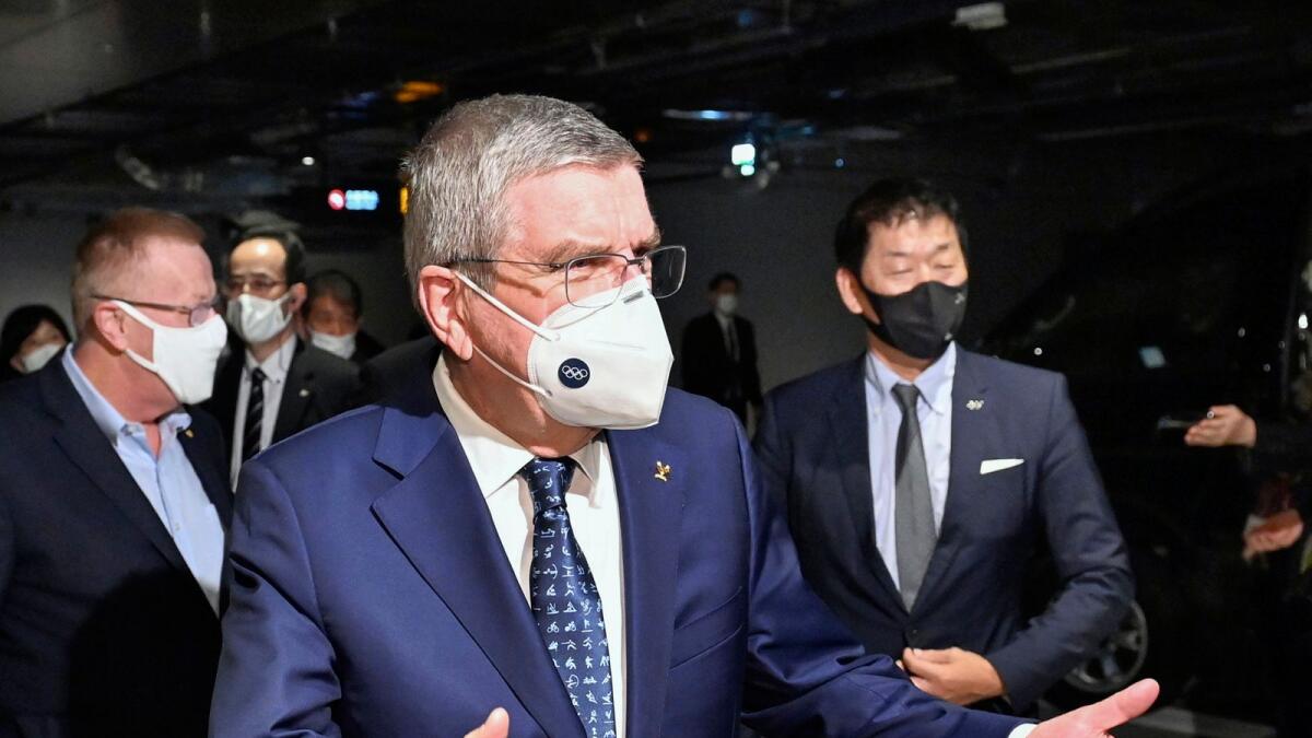 International Olympic Committee President Thomas Bach (front) arrives at a hotel in Tokyo on Sunday.— AFP