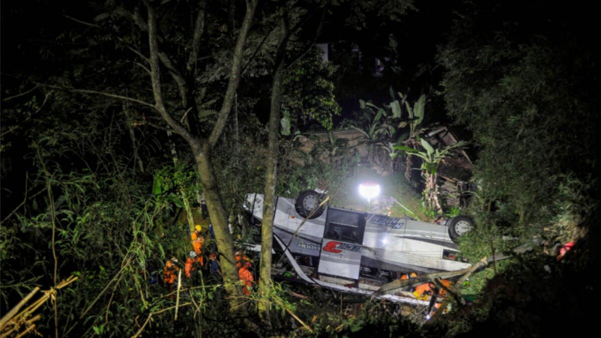 Rescue personnel work at the crash site after a bus fell into a ravine in Sumedang, West Java Province in Indonesia. — Reuters