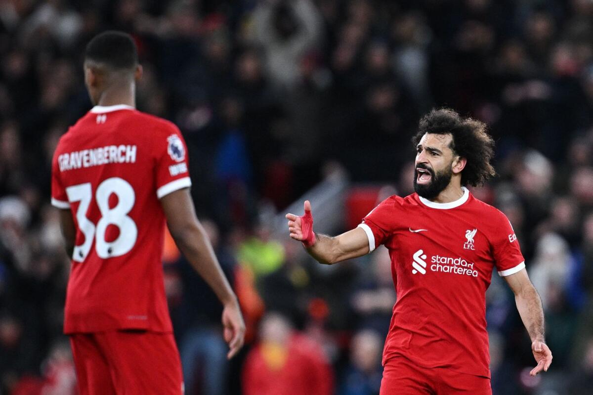 Liverpool's Egyptian striker Mohamed Salah reacts after scoring during the English Premier League against Arsenal. - AFP