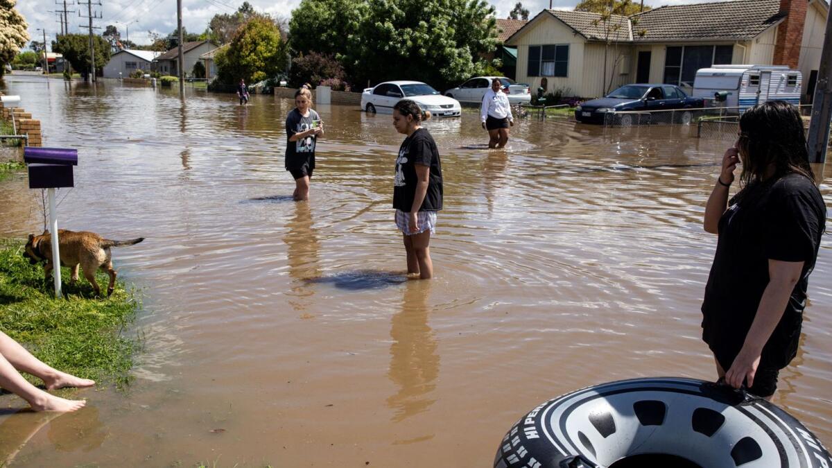 Local residents wade through floodwaters in Shepparton as the state of Victoria faces an ongoing flood crisis. — Reuters