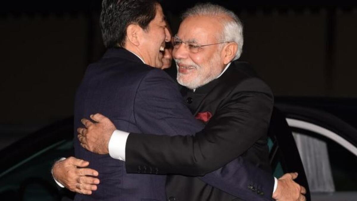 India's Prime Minister Narendra Modi (R) is welcomed by Japan's Prime Minister Shinzo Abe upon his arrival at the State Guest House in Kyoto, western Japan, in this photo released by Kyodo.