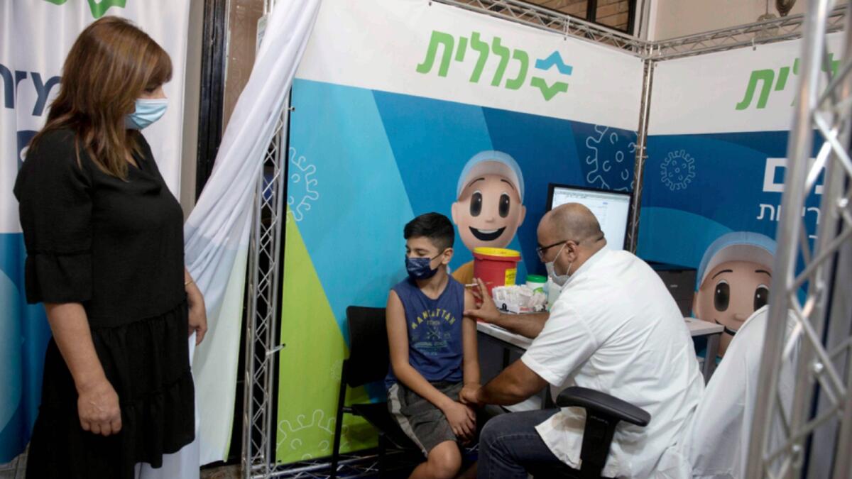 A 12-year-old boy receives Covid-19 vaccine in Jerusalem. — AP file