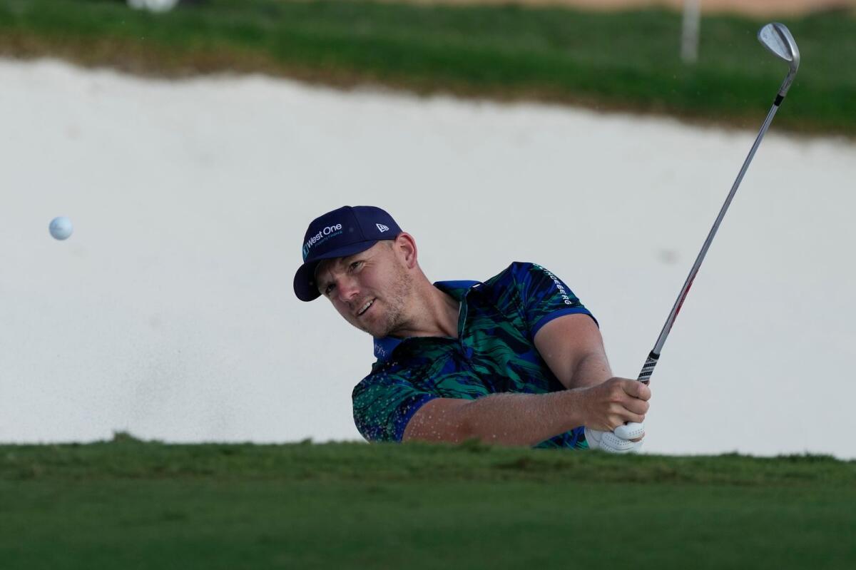 Matt Wallace of England plays a bunker shot on the 18th hole during the DP World Tour Championship. - AP