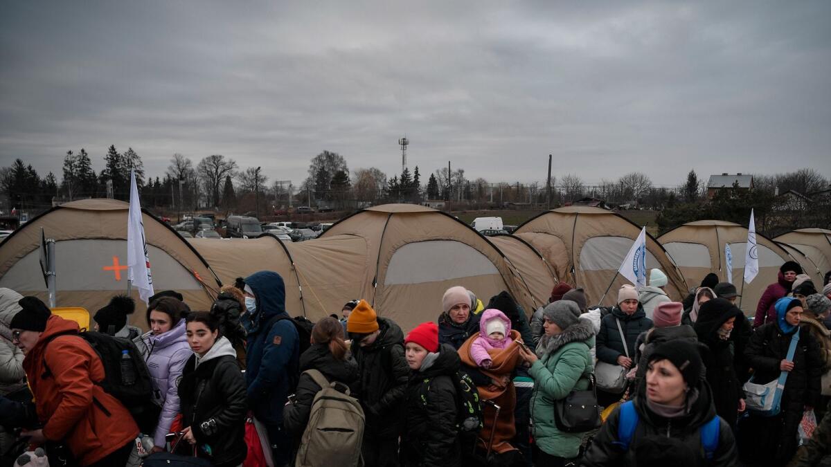 Refugees from Ukraine wait for transportation after crossing the Ukrainian-Polish border in Medyka southeastern Poland on March 9, 2022.Photo: AFP