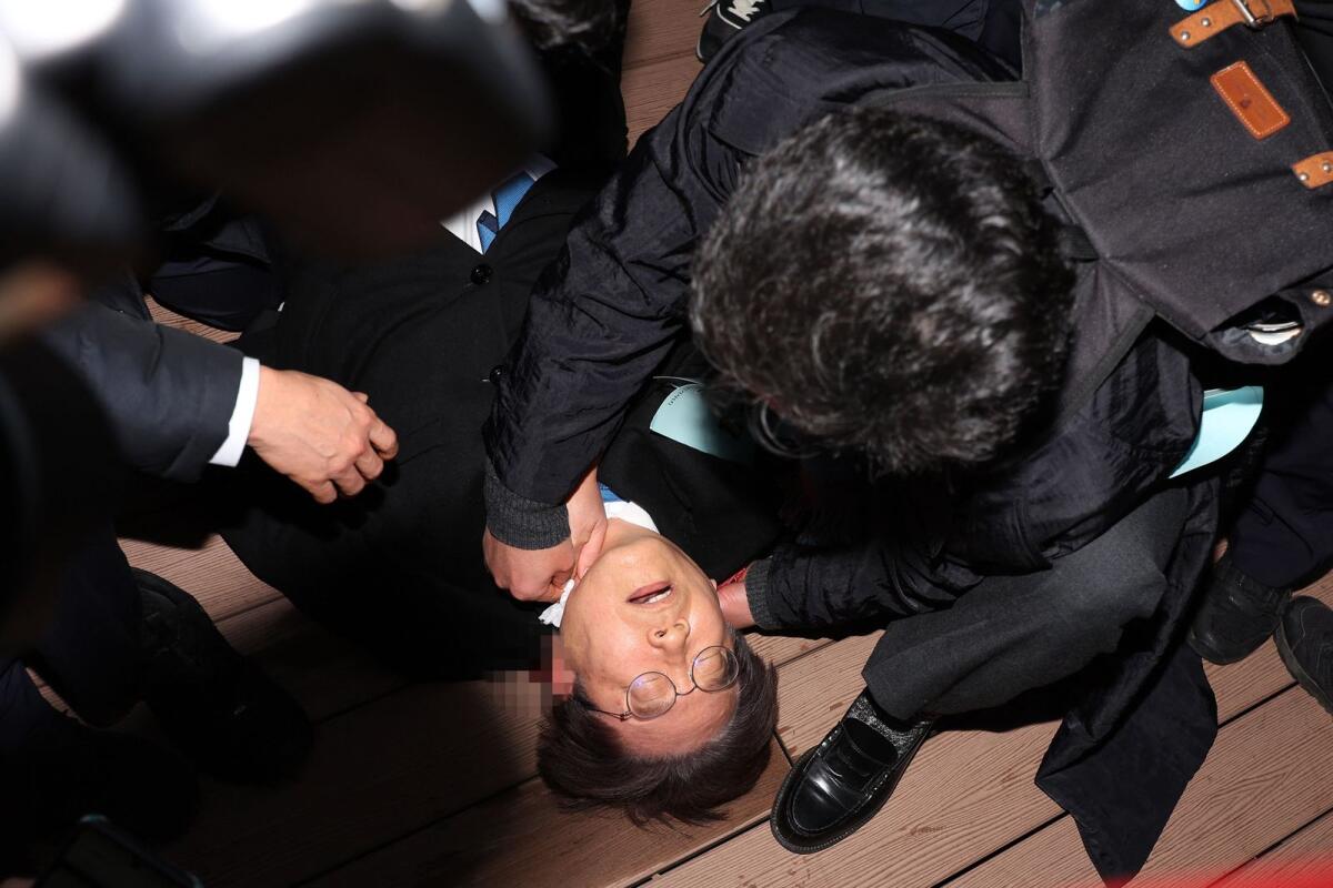South Korean opposition party leader Lee Jae-myung is attended to after being attacked in Busan on January 2, 2024. Photo: AFP