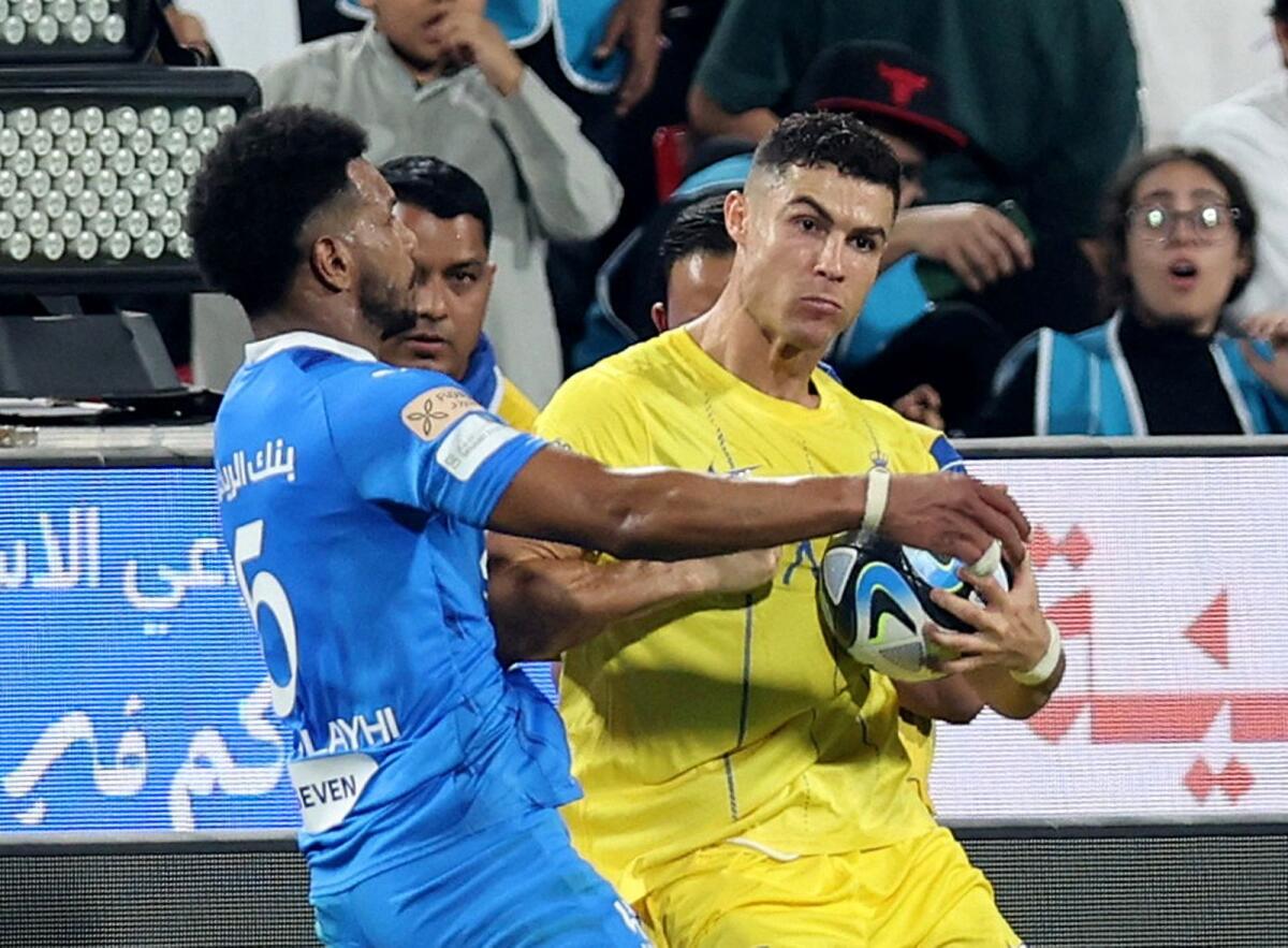 Al Nassr's Cristiano Ronaldo clashes with Al Hilal's Ali Al Bulayhi before being shown a red card by referee Mohammed Al Hoaish. — Reuters