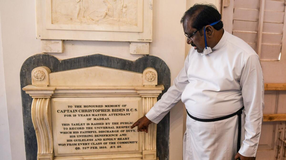 A pastor shows a memorial tablet of Christoper Biden, a potential ancestor of US President-elect Joe Biden, at the St George's Cathedral in Chennai.