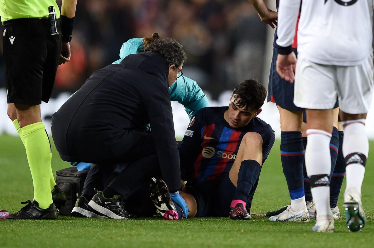Barcelona midfielder Pedri receives medical attention during the Europa League match against Manchester United at the Camp Nou. — AFP