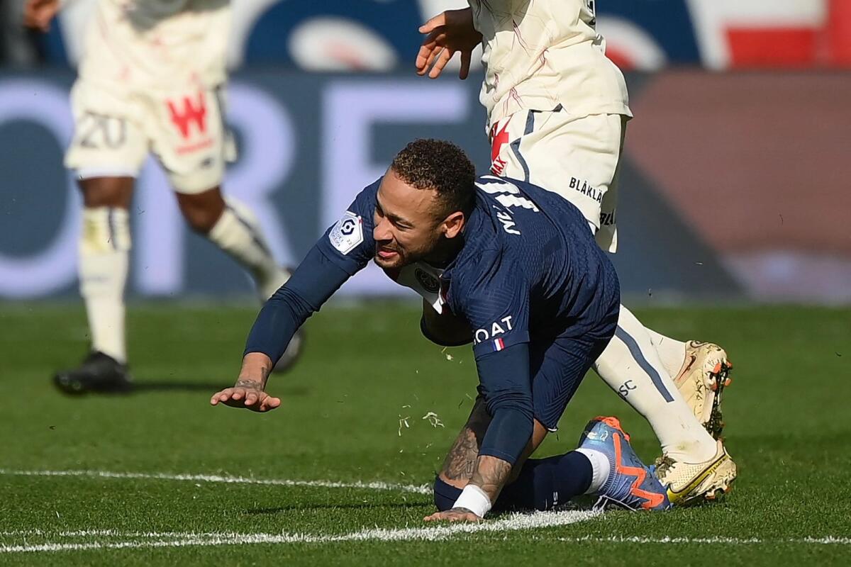 Paris Saint-Germain's Neymar falls after a contact with Lille's Benjamin Andre. — AFP