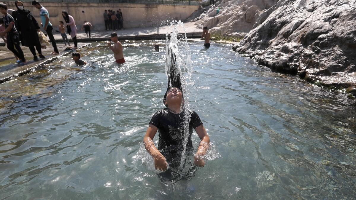 Iranian youths cool down in the Cheshmeh Ali natural spring pool in Shahr-e-Rey neighbourhood in the south of the capital Tehran. Photo: AFP