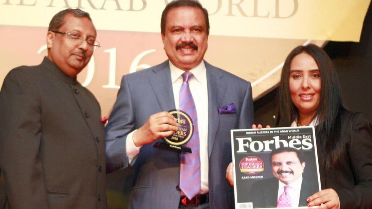 Dr Azad Moopen, chairman of DM Group, receives the 'Top Indian Business leader in the Arab region' award in Dubai on Tuesday. Also seen is T.P. Seetharam, Indian Ambassador to the UAE, and a senior Forbes executive.