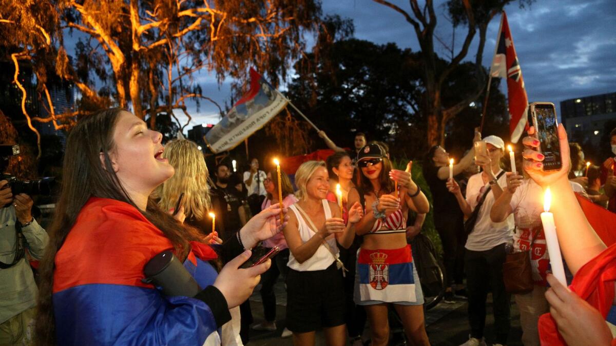 Supporters of Serbia's Novak Djokovic protest and sing with candles outside a quarantine facility where Djokovic is believed to be detained, in Melbourne, Australia on Thursday. — AP