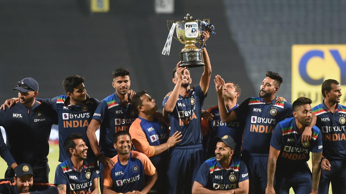 Indian team with the trophy after winning the ODI series against England in Pune. — PTI