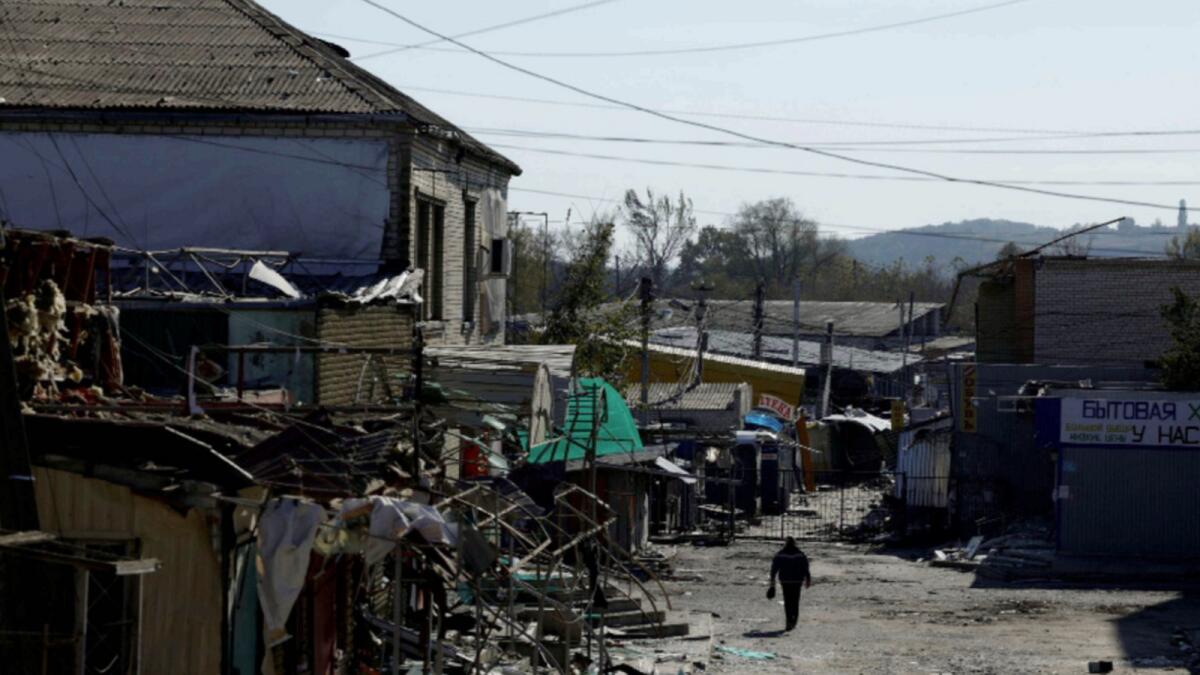 A man walks through a shopping street destroyed by Russian strikes in the recently liberated town of Kupiansk. — Reuters
