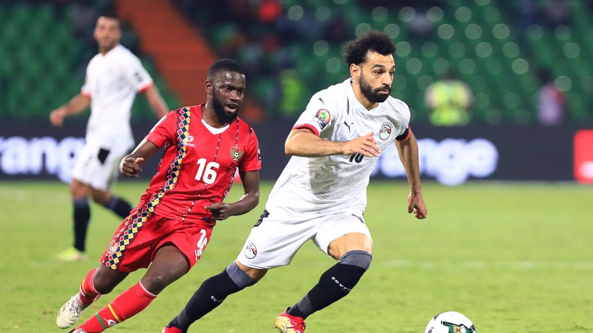 Egypt's Mohamed Salah (right) gets past Guinea-Bissau's Moreto Cassama. — AFP