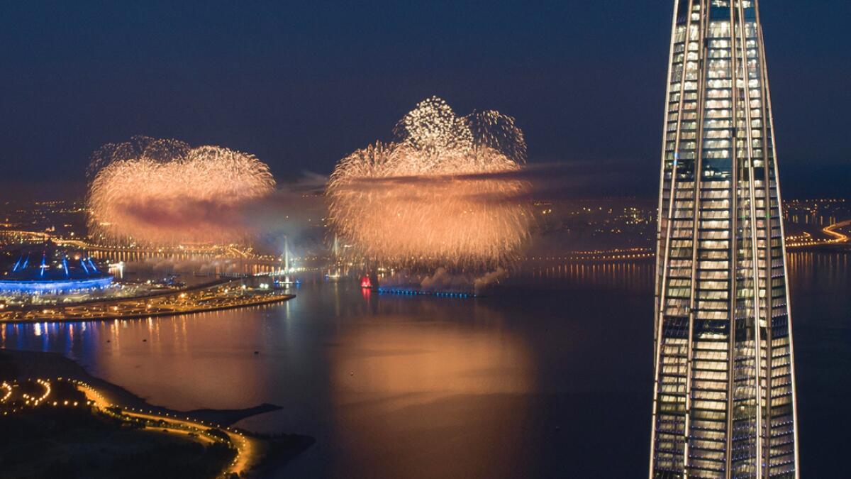 In this aerial photo a brig with scarlet sails, center, travels and fireworks explode at the Finnish Gulf coast during the Scarlet Sails festivities marking school graduation in St. Petersburg, Russia, with business tower Lakhta Centre, the headquarters of Russian gas monopoly Gazprom on the right. This year the festival is not to be held in the city center, but on the Finnish Gulf due to the coronavirus pandemic. There are no spectators but the event is broadcast on television.  Photo: AP