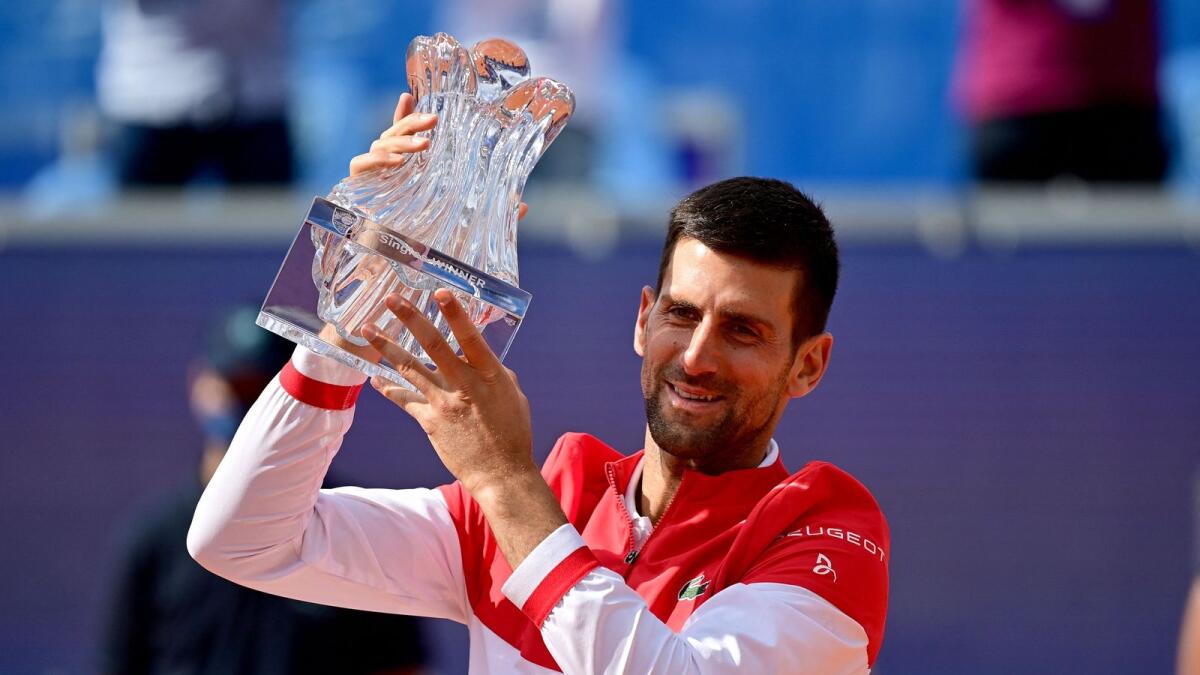 Novak Djokovic holds the winning trophy after his final match against Slovakian Alex Molcan at the Belgrade Open tennis tournament. — AFP