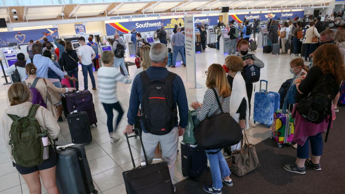 Travellers wait to check in at the Southwest Airlines ticketing counter at Baltimore Washington International Thurgood Marshall Airport on October 11, 2021 in Baltimore, Maryland. (AFP)